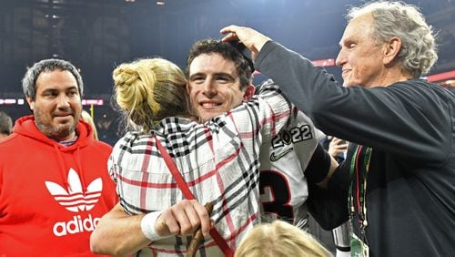 Georgia's quarterback Stetson Bennett (13) celebrates with his family after Georgia won 2022 College Football Playoff National Championship at Lucas Oil Stadium in Indianapolis on Monday, January 10, 2022. (Hyosub Shin / Hyosub.Shin@ajc.com)