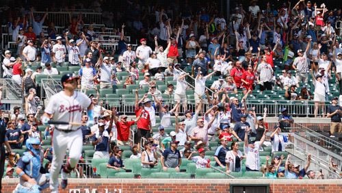 Atlanta Braves fans jump off their seat as they watch Braves third baseman Austin Riley (27) hitting a two-run home run at the bottom of the eighth inning against the Tampa Bay Rays at Truist Park on Sunday, June 16, 2024, in Atlanta. 
(Miguel Martinez/ AJC)