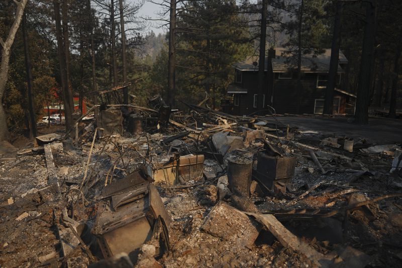 A fire-ravaged property is seen after the Bridge Fire swept through, Thursday, Sept. 12, 2024, in Wrightwood, Calif. (AP Photo/Eric Thayer)