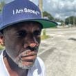 Jazz Watts, a resident of Sapelo Island, wears a hat that reads "I am Sapelo" outside the McIntosh County courthouse in Darien, Ga., on Friday, Sept. 20, 2024. (Russ Bynum/AP)