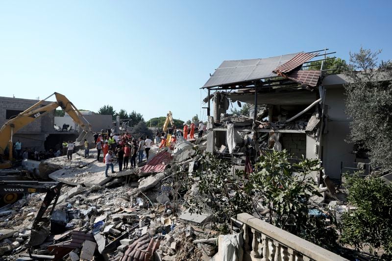 Emergency workers arrive at the scene of an Israeli airstrike in the town of Maisara, north of Beirut, Wednesday, Sept. 25, 2024. (AP Photo/Bilal Hussein)