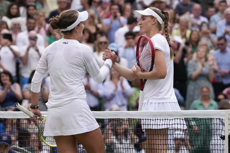 Barbora Krejcikova, left, of the Czech Republic is congratulated by Elena Rybakina of Kazakhstan following their semifinal match at the Wimbledon tennis championships in London, Thursday, July 11, 2024. (AP Photo/Alberto Pezzali)