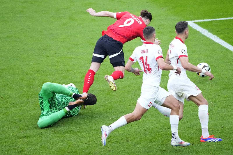 Poland's goalkeeper Wojciech Szczesny fauls Austria's Marcel Sabitzer in the box to give away a penalty shot during a Group D match between Poland and Austria at the Euro 2024 soccer tournament in Berlin, Germany, Friday, June 21, 2024. (AP Photo/Petr Josek)