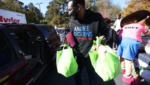 Then-Mayoral candidate Andre Dickens loads bags of food into a car during a Thanksgiving  food giveaway in southwest Atlanta. Saturday, November 20, 2021. Miguel Martinez for The Atlanta Journal-Constitution