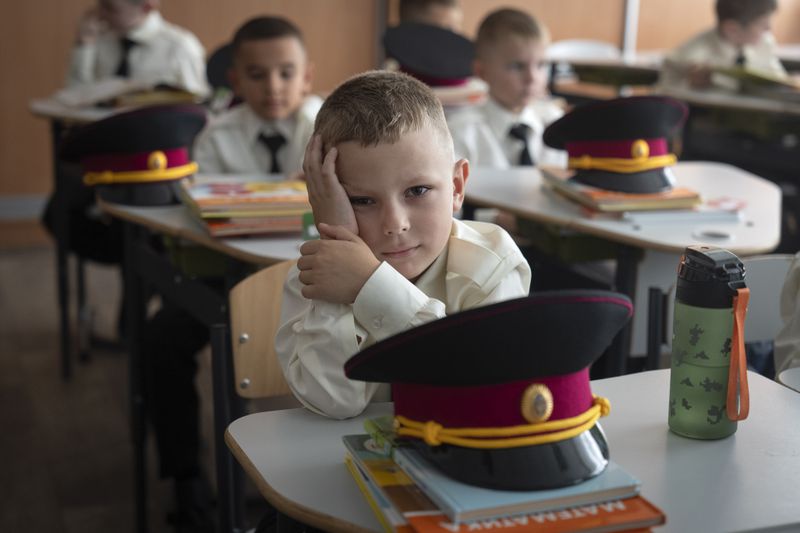 Young cadets attend the first lesson in a cadet lyceum on the first day at school in Kyiv, Ukraine, Monday, Sept. 2, 2024. Children and students went to school despite the fact that Kyiv was hit by massive Russian missile barrage early in the morning, causing fires, damaged buildings and infrastructure objects. (AP Photo/Efrem Lukatsky)