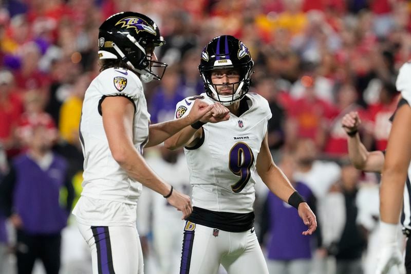 Baltimore Ravens kicker Justin Tucker (9) is congratulated by teammate Jordan Stout after making a 25-yard field goal during the first half of an NFL football game against the Kansas City Chiefs Thursday, Sept. 5, 2024, in Kansas City, Mo. (AP Photo/Ed Zurga)