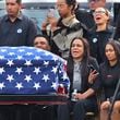 Sandra Garcia, center, sits with other family members as pallbearers carry the casket of her son, Massachusetts State Police recruit Enrique Delgado-Garcia, during his funeral service at the Mercadante Funeral Home in Worcester, Mass., Saturday, Sept. 24, 2024. (John Tlumacki/The Boston Globe via AP)