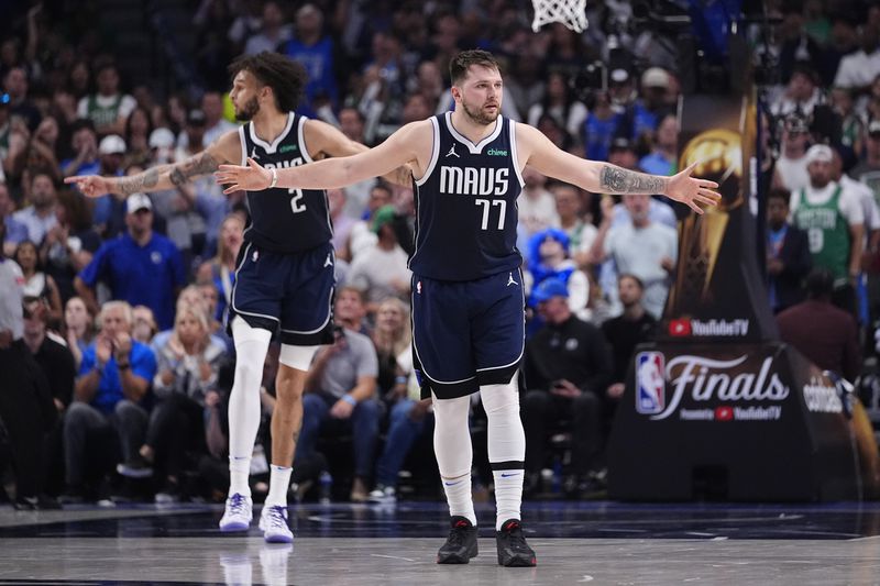 Dallas Mavericks guard Luka Doncic (77) and center Dereck Lively II (2) prepare their defense against the Boston Celtics during the first half in Game 4 of the NBA basketball finals, Friday, June 14, 2024, in Dallas. (AP Photo/Julio Cortez)