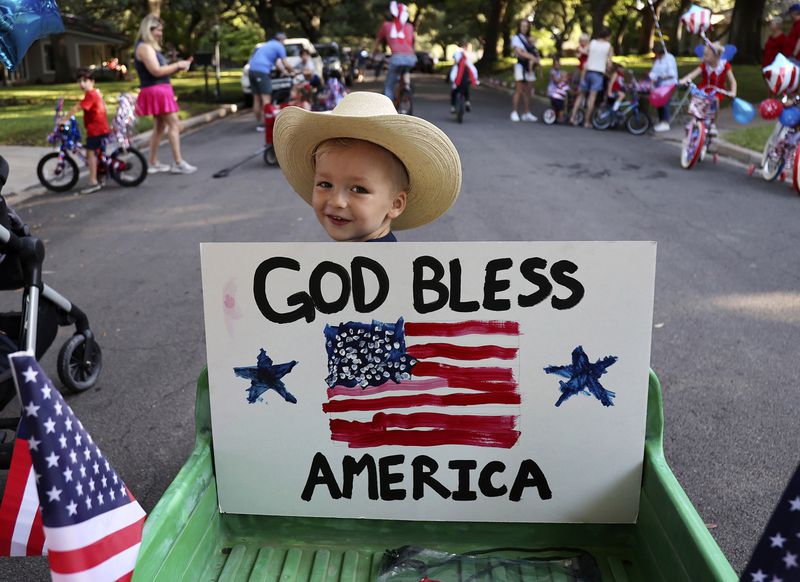 Niels Jacobsen, 3, waits for the Old Oaks neighborhood parade to begin on the Fourth of July, in Waco, Texas, Thursday, July 4, 2024. The parade is over thirty years old. (Jerry Larson/Waco Tribune-Herald, via AP)