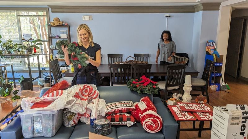 Volunteers Amy Williams and Carla Jackson prepare Christmas decorations for one of two campus houses in Kennesaw State University’s Ascend Community that serve once-homeless students. The Cobb Community Foundation connects volunteers to nonprofits and projects addressing various needs in the county. Courtesy of Leadership Cobb Alumni Association