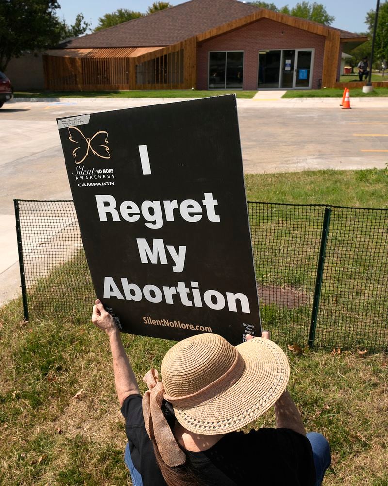 Anti-abortion protester Deborah Green-Myers, from Pittsburg, Kan., demonstrates outside a recently opened Planned Parenthood clinic, Tuesday, Sept. 10, 2024, in Pittsburg, Kan. (AP Photo/Charlie Riedel)