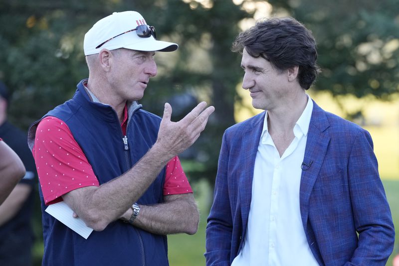 United States team captain Jim Furyk chats with Canada Prime Minister Justin Trudeau before the trophy presentation at the Presidents Cup golf tournament at Royal Montreal Golf Club Sunday, Sept. 29, 2024 in Montreal. (Frank Gunn/The Canadian Press via AP)