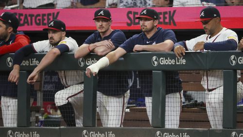 Injured Atlanta Braves third baseman Austin Riley, center, stands next to left fielder Adam Duvall, left, and starting pitcher Max Fried, second from left, during the ninth inning of their game against the Philadelphia Phillies at Truist Park, Thursday, August 22, 2024, in Atlanta. The Braves won 3-2. (Jason Getz / AJC)
