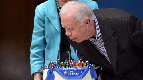 Former President Jimmy Carter blows out the candles on his cake during his 90th birthday celebration in October 2014.
HYOSUB SHIN / HSHIN@AJC.COM