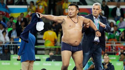 Coach strips to underwear to protest Olympic wrestling match