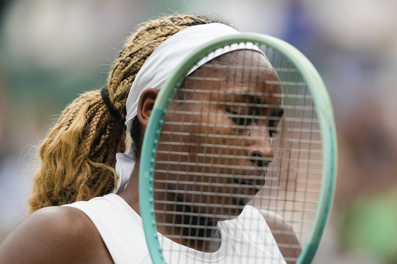 Coco Gauff of the United States plays a prepares to serve to Anca Todoni of Romania during their match on day three at the Wimbledon tennis championships in London, Wednesday, July 3, 2024. (AP Photo/Mosa'ab Elshamy)
