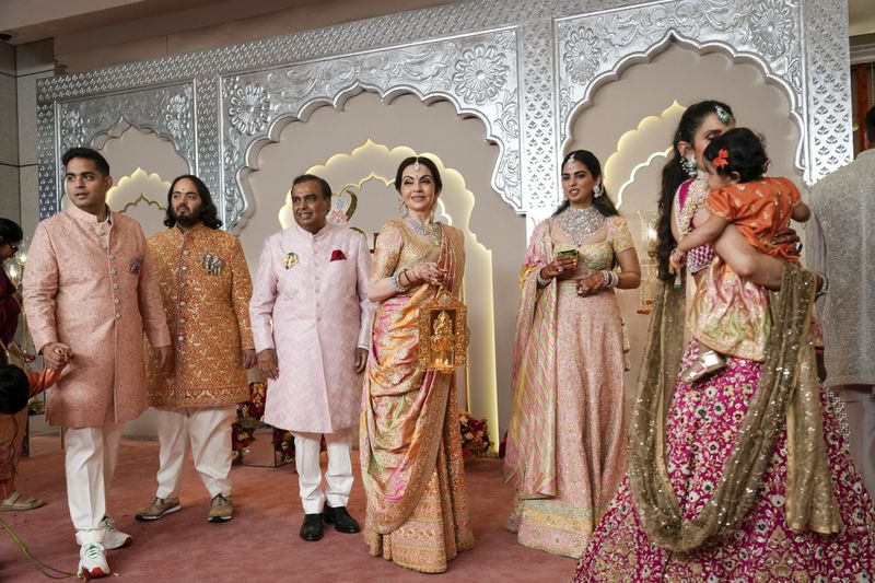 Billionaire Mukesh Ambani, third left, stands with his family members from L to R, son Akash, son Anant, wife Neeta, daughter Isha and daughter-in-law Shloka at the wedding of his son Anant Ambani and Radhika Merchant at Jio World Convention Centre in Mumbai, India, Friday, July 12, 2024. (AP Photo /Rajanish Kakade)