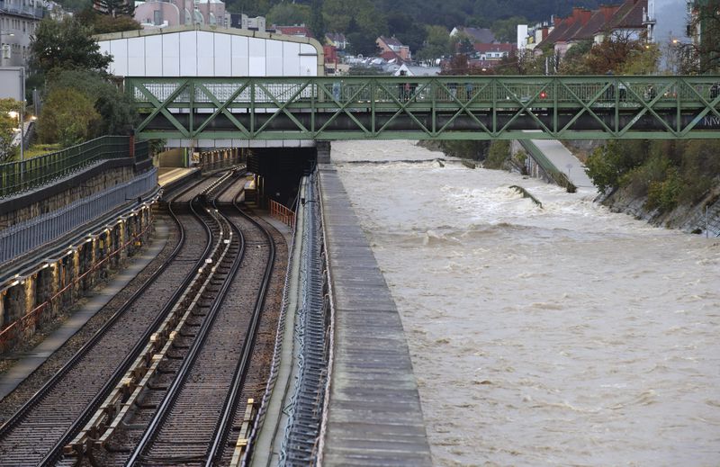 River Wien floods its banks next to tracks and a closed subway station in the west of Vienna, Austria, Sunday, Sept. 15, 2024. (AP Photo/Heinz-Peter Bader)