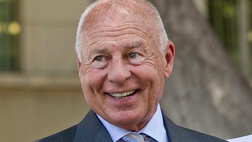 FILE - Attorney Tom Girardi smiles outside the Los Angeles courthouse, July 9, 2014. (AP Photo/Damian Dovarganes, File)