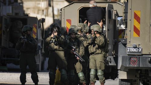 Israeli soldiers arrest a blindfolded Palestinian during an army raid in Tubas, West Bank, on Wednesday, Sept. 11, 2024. (AP Photo/Majdi Mohammed)