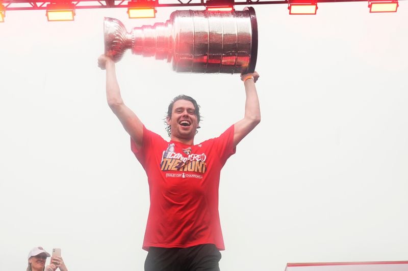 Florida Panthers center Carter Verhaeghe raises the Stanley Cup during an NHL hockey parade and rally, Sunday, June 30, 2024, in Fort Lauderdale, Fla. Verhaeghe scored the winning goal to defeat the Edmonton Oilers and win the cup. (AP Photo/Marta Lavandier)