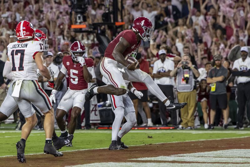 Alabama quarterback Jalen Milroe (4) scores on a running play against Georgia during the first half of an NCAA college football game, Saturday, Sept. 28, 2024, in Tuscaloosa, Ala. (AP Photo/Vasha Hunt)