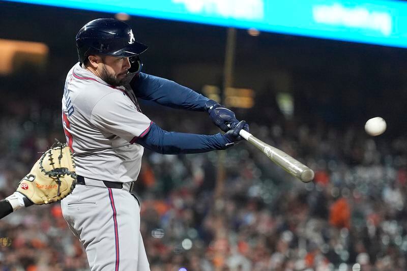 Atlanta Braves' Travis d'Arnaud hits a sacrifice fly that scored Orlando Arcia during the 10th inning of a baseball game against the San Francisco Giants in San Francisco, Monday, Aug. 12, 2024. (AP Photo/Jeff Chiu)