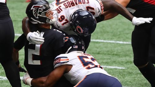 Falcons quarterback Matt Ryan is sacked and stripped of the ball by Chicago Bears linebacker Khalil Mack as he is leveled by Mario Edwards, who was called for unnecessary roughness, for what looked to be a turnover during the second quarter Sunday, Sept. 27, 2020, in Atlanta. The Bears had 2 penalties on the play negating the turnover.   (Curtis Compton / Curtis.Compton@ajc.com)