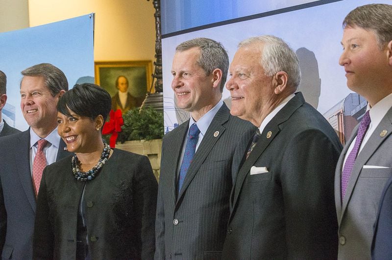 Gov.-elect Brian Kemp, from left, Atlanta Mayor Keisha Lance Bottoms, Norfolk Southern CEO Jim Squires, Gov. Nathan Deal and state Economic Development Commissioner Pat Wilson stand for a photo following a press conference at the Georgia Capitol in December 2018 announcing that the railway would be moving its headquarters to Atlanta. (Alyssa Pointer/ AJC FILE PHOTO)