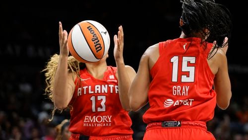 Atlanta Dream guard Haley Jones (13) makes a rebound by teammate Allisha Gray (15) during the first half of an WNBA basketball game against the Las Vegas Aces Friday, Aug. 30, 2024 in Las Vegas. (Steve Marcus/Las Vegas Sun via AP)