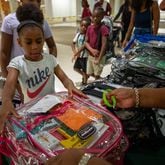 Makayla Smith receives a free school supply kit and clear backpack at the 20th annual Back-to-School Bash at Greenbriar Mall in Atlanta on Saturday, July 22, 2023. (Katelyn Myrick/AJC)