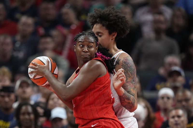 Indiana Fever forward Aliyah Boston, left, goes to the basket against Phoenix Mercury's Brittney Griner, right, during the first half of a WNBA basketball game, Friday, Aug. 16, 2024, in Indianapolis. (AP Photo/Darron Cummings)