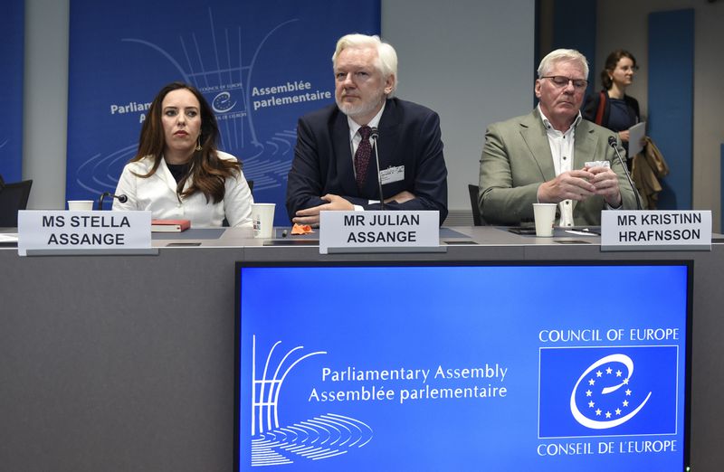 Wikileaks founder Julian Assange, center, his wife Stella Assange, left, and editor-in-chief of WikiLeaks Kristin Hrafnsson, listen the open speech at the Council of Europe while his wife Stella Assange sits next to him, in Strasbourg, eastern France, Tuesday, Oct. 1, 2024. (AP Photo/Pascal Bastien)