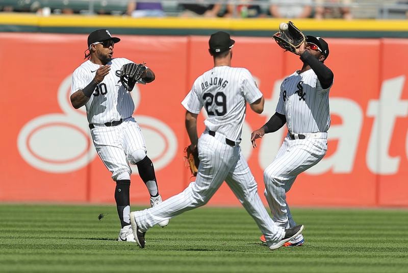 Chicago White Sox's Corey Julks, left, avoids Luis Robert Jr. as he makes a catch for an out during the fourth inning of a baseball game against the Chicago White Sox, Thursday, June 27, 2024, in Chicago. (AP Photo/Melissa Tamez)