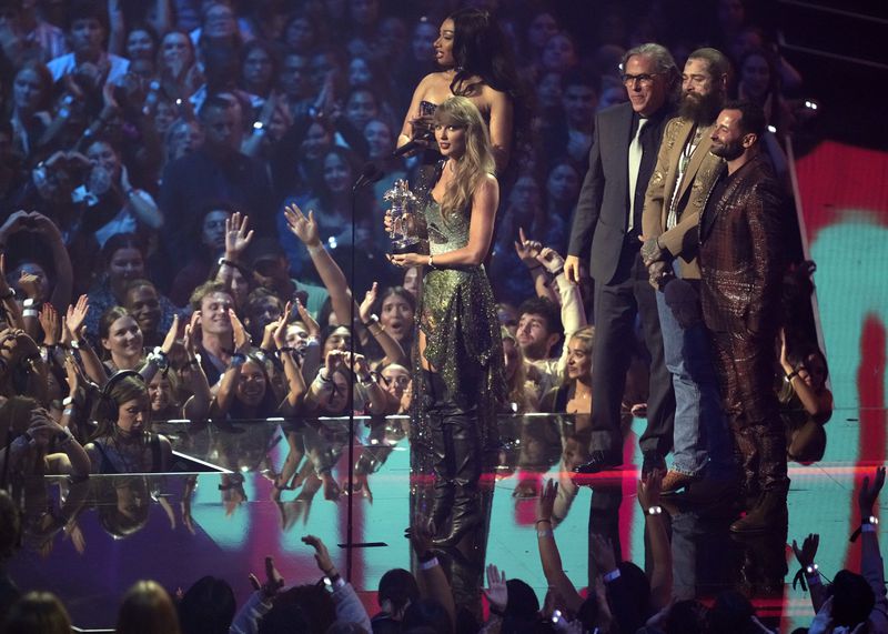 Taylor Swift, center, and Post Malone, third from back left, accept the video of the year award for "Fortnight" during the MTV Video Music Awards on Wednesday, Sept. 11, 2024, at UBS Arena in Elmont, N.Y. Host Megan Thee Stallion, from far left back, Rodrigo Prieto, and Ethan Tobman, far right, look on. (Photo by Charles Sykes/Invision/AP)