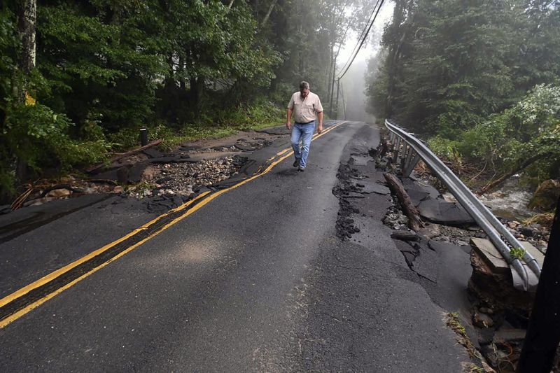 Skip Kearns, with the Connecticut Department of Energy and Environmental Protection, looks over damage on Georges Hill Rd., in Southbury, Conn., Monday, Aug. 19, 2024. ( Jim Michaud/Hearst Connecticut Media via AP)