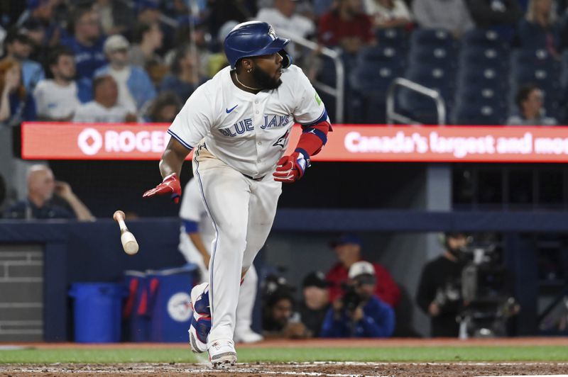 Toronto Blue Jays' Vladimir Guerrero Jr. (27) hits a double against the Philadelphia Phillies in the eighth inning of a baseball game in Toronto on Tuesday, Sept. 3, 2024. (Jon Blacker/The Canadian Press via AP)