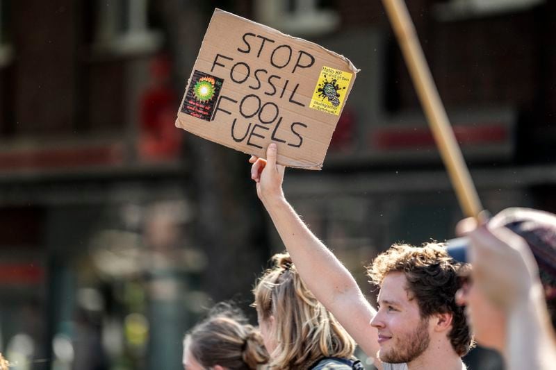 People demonstrate with a sign reading "stop fossil fuels" in the City of Bochum, western Germany, as they take part in a Global Climate Strike protest of the Fridays For Future movement on Friday, Sept. 20, 2024. (AP Photo/Martin Meissner)