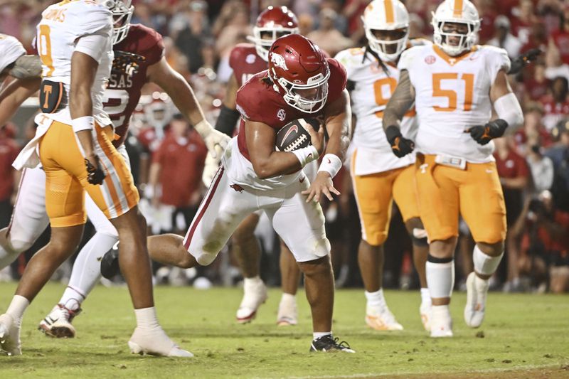 Arkansas quarterback Malachi Singleton (3) runs for a touchdown against Tennessee during the second half of an NCAA college football game Saturday, Oct. 5, 2024, in Fayetteville, Ark. (AP Photo/Michael Woods)