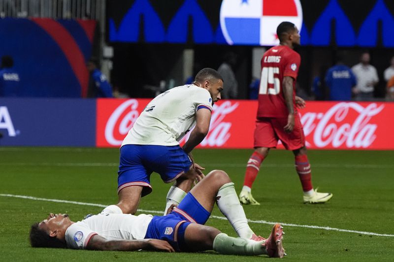 Chris Richards of the United States lies on the pitch after losing1-2 against Panama at the end of a Copa America Group C soccer match in Atlanta, Thursday, June 27, 2024. (AP Photo/Mike Stewart)