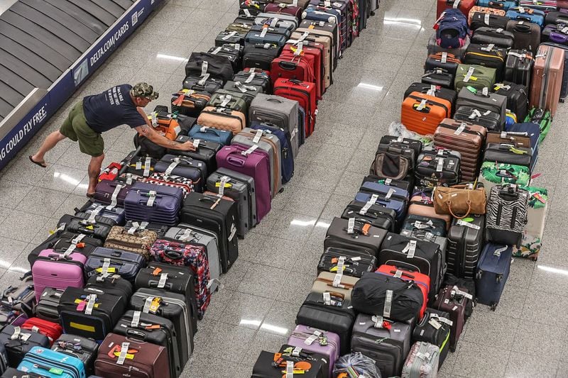 Rows of baggage on the floors in the baggage claim area of the domestic terminal at Hartsfield-Jackson International Airport on Tuesday, July 23, 2024, on the fifth day of a massive global technology outage that has severely impacted the operations of Delta Air Lines. John Spink/AJC