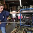 Mechanic Carlos Fernandez tests a generator that was brought in for repair at Blast Off Equipment in West Palm Beach.