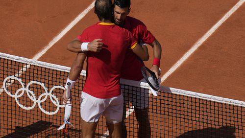 Serbia's Novak Djokovic, right, hugs Spain's Rafael Nadal after their men's singles second round match at the Roland Garros stadium at the 2024 Summer Olympics, Monday, July 29, 2024, in Paris, France. Novak Djokovic dominated rival Rafael Nadal to win 6-1, 6-4 at the Paris Olympics in the second round. (AP Photo/Manu Fernandez)