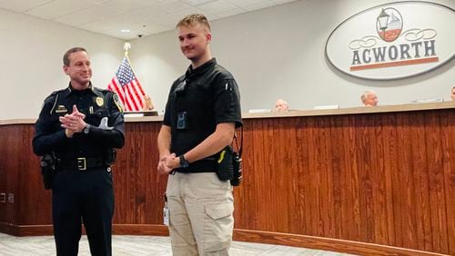 Acworth police Chief Jesse Evans (left) introduces Public Safety Liaison, Justin Reaid at a recent city council meeting.