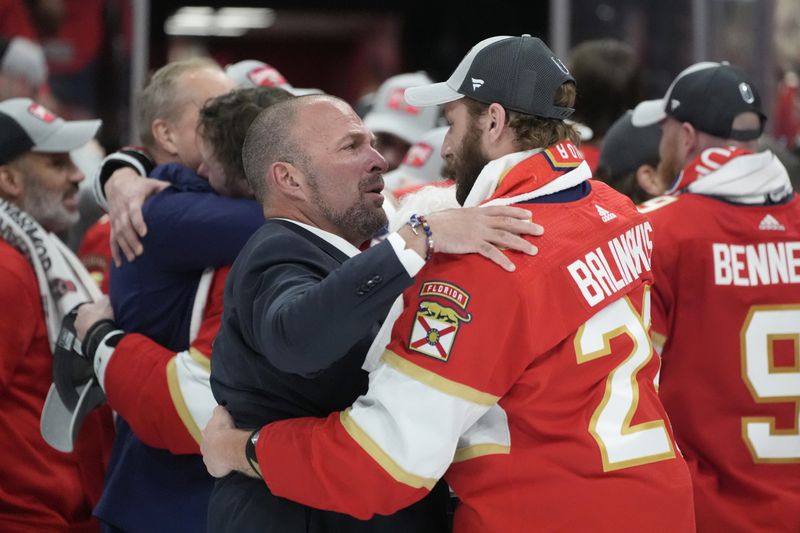 FILE - Florida Panthers general manager Bill Zito talks to defenseman Uvis Balinskis (26) after Game 7 of the NHL hockey Stanley Cup Final against the Edmonton Oilers, on June 24, 2024, in Sunrise, Fla. (AP Photo/Wilfredo Lee, File)