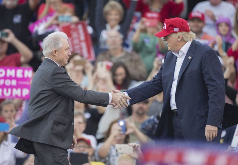 U.S. Sen. Jeff Sessions, nominated to be the attorney general, greets President-elect Donald Trump during a rally in Mobile, Alabama, in December. (AP photo)