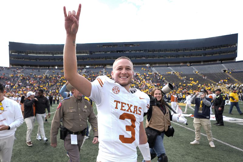 Texas quarterback Quinn Ewers smiles while acknowledging the crowd after an NCAA college football game against Michigan in Ann Arbor, Mich., Saturday, Sept. 7, 2024. (AP Photo/Paul Sancya)