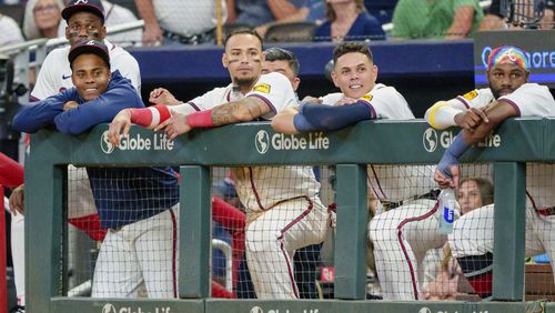 Atlanta Braves outfielder Jorge Soler, far left, pitcher Raisel Iglesias, left with blue sweatshirt, shortstop Orlando Arcia center left, third baseman Gio Urshela, center right, and outfielder Michael Harris II, right, watch Marcell Ozuna (20) at bat in the ninth inning of a baseball game against the Colorado Rockies, Thursday, Sept. 5, 2024, in Atlanta. (AP Photo/Jason Allen)