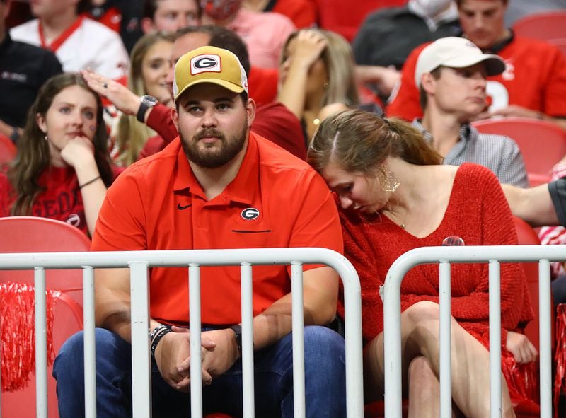 Georgia fans react as their team falls behind 38-17 to Alabama in the SEC Championship game on Saturday, Dec 4, 2021, in Atlanta.   “Curtis Compton / Curtis.Compton@ajc.com”`