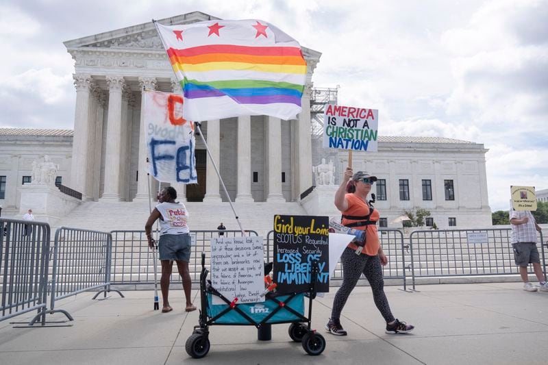 Demonstrators stand outside the Supreme Court on Thursday, June 27, 2024, in Washington. The Supreme Court cleared the way Thursday for Idaho hospitals to provide emergency abortions for now in a procedural ruling that left key questions unanswered and could mean the issue ends up before the conservative-majority court again soon. (AP Photo/Mark Schiefelbein)